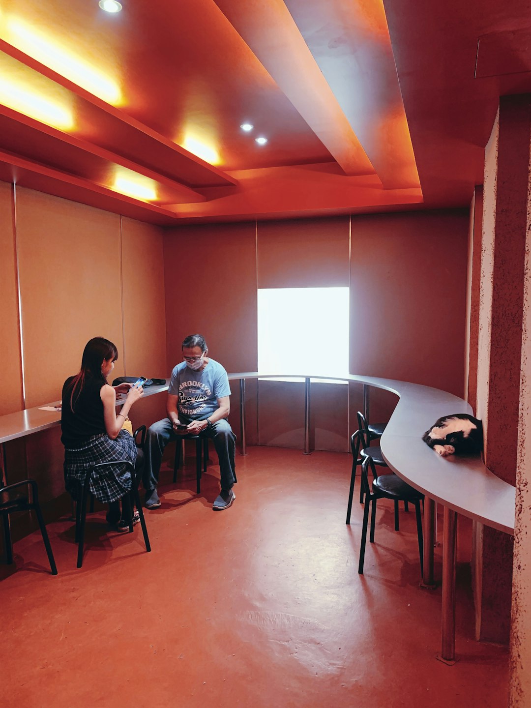 a-man-and-a-woman-sitting-at-a-table-in-a-room-vveo40ox7gi